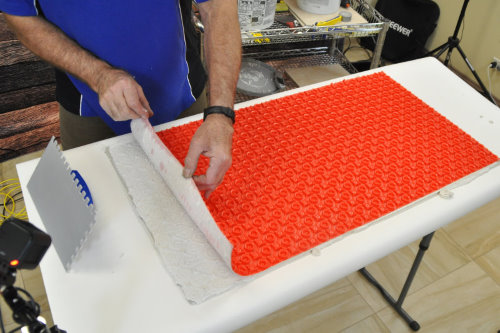 Floor heating with ThermoTile cable on PROVA membrane installation step 3 - Spread thinset on subfloor and install membrane. Step 3 of installation of floor heating with ThermoTile cable on PROVA membrane is to spread thinset on subfloor and install. membrane.